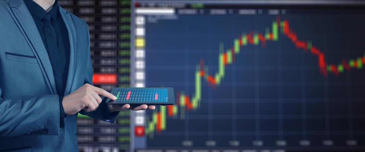 Biznesmen analizujący wykresy finansowe na tablecie, prognozy ZUS w 2026 roku.