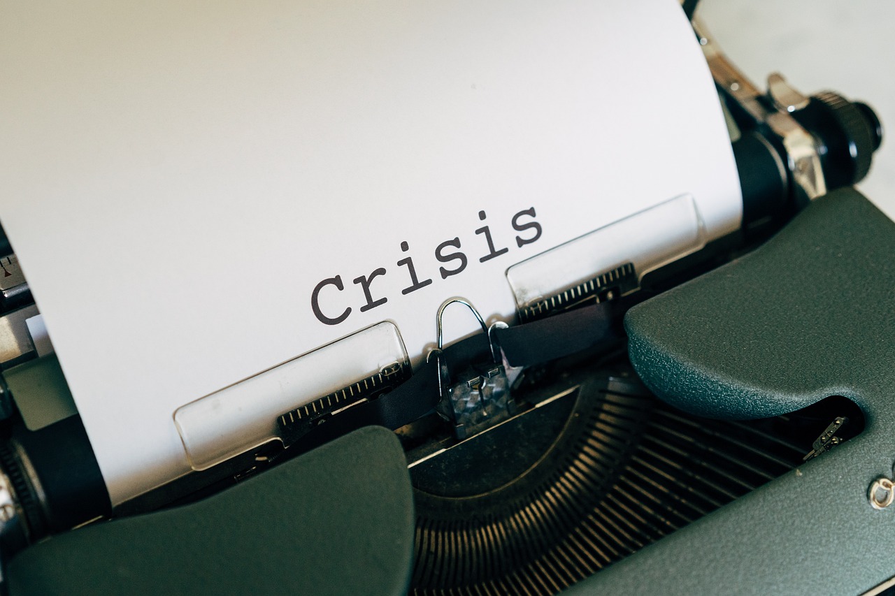 Maszyna do pisania z kartką z napisem 'Crisis' - symbol inflacji w Polsce.